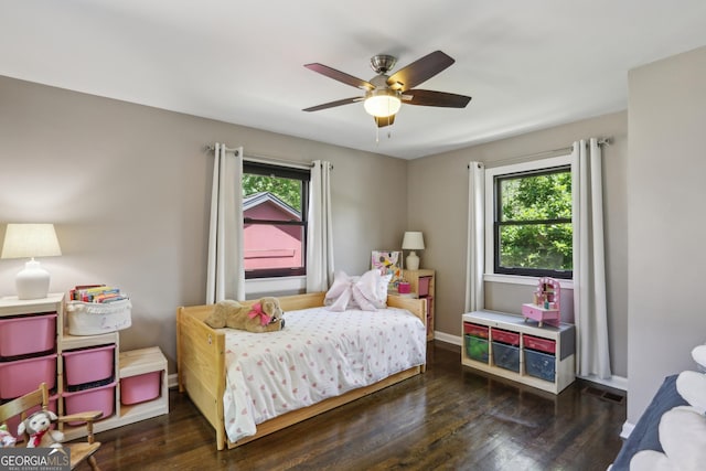 bedroom with wood finished floors, ceiling fan, and baseboards