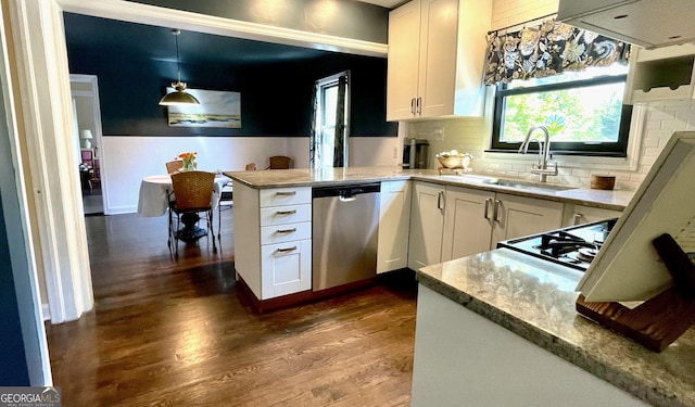 kitchen with stainless steel dishwasher, a sink, a peninsula, dark wood-type flooring, and white cabinets