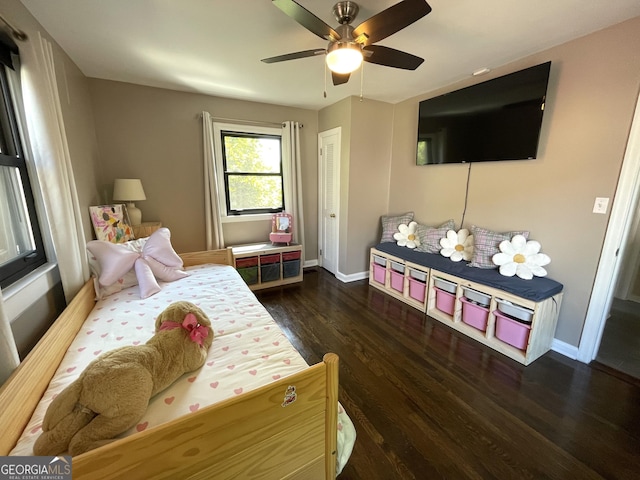 bedroom featuring wood finished floors, baseboards, and ceiling fan