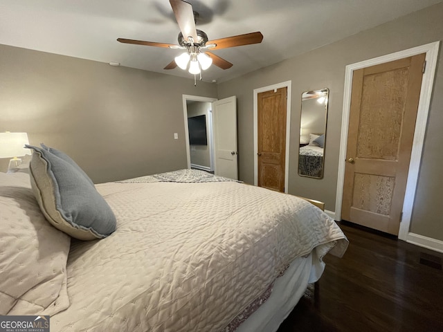 bedroom with wood finished floors, baseboards, and a ceiling fan