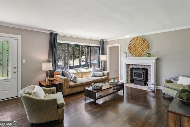 living room featuring crown molding, wood finished floors, and a wood stove
