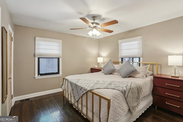 bedroom with dark wood-style flooring, baseboards, and ceiling fan