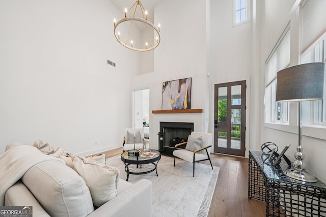 135 Channing Ln, Fayetteville, GA 30214 - living room featuring a high ceiling, a chandelier, hardwood / wood-style floors, and a fireplace