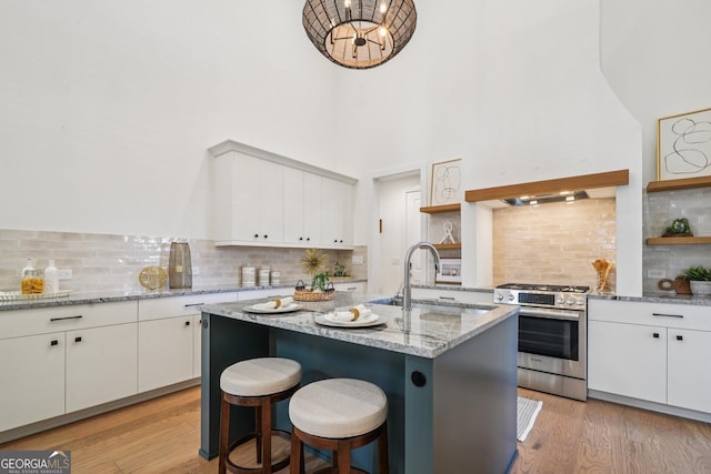 135 Channing Ln, Fayetteville, GA 30214 - kitchen with gas range, open shelves, tasteful backsplash, white cabinetry, and a high ceiling