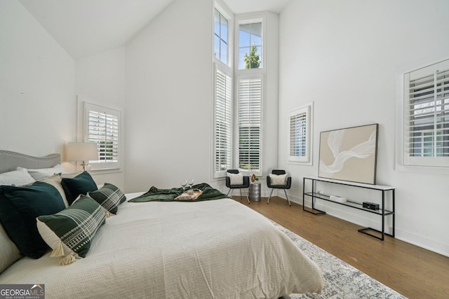 135 Channing Ln, Fayetteville, GA 30214 - bedroom with high vaulted ceiling, multiple windows, and wood finished floors