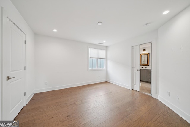 135 Channing Ln, Fayetteville, GA 30214 - unfurnished bedroom with wood finished floors, recessed lighting, and ensuite bath