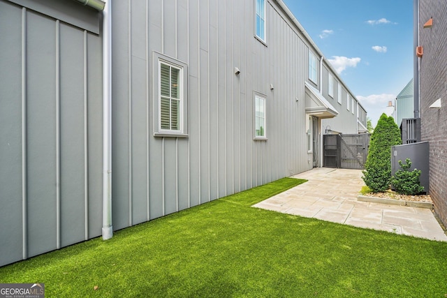 135 Channing Ln, Fayetteville, GA 30214 - back of house featuring a gate, board and batten siding, and a patio