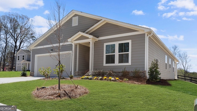 view of front of property featuring a garage, driveway, and a front lawn
