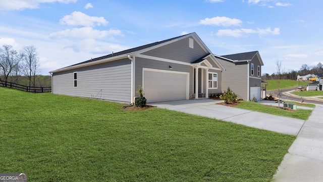 view of property exterior with concrete driveway, a garage, fence, and a lawn
