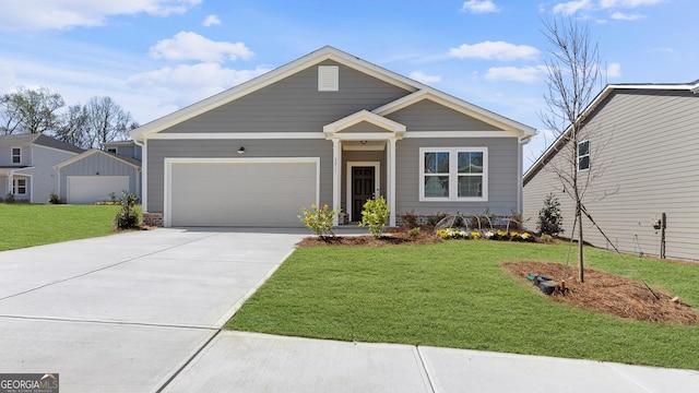 view of front facade with a front lawn, an attached garage, and concrete driveway