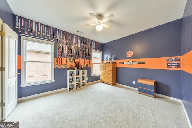 unfurnished bedroom with carpet flooring, baseboards, visible vents, and ceiling fan