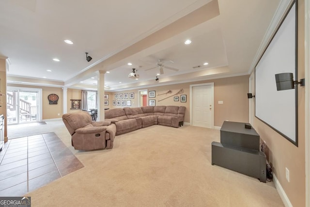 living room featuring carpet flooring, decorative columns, a raised ceiling, and ornamental molding