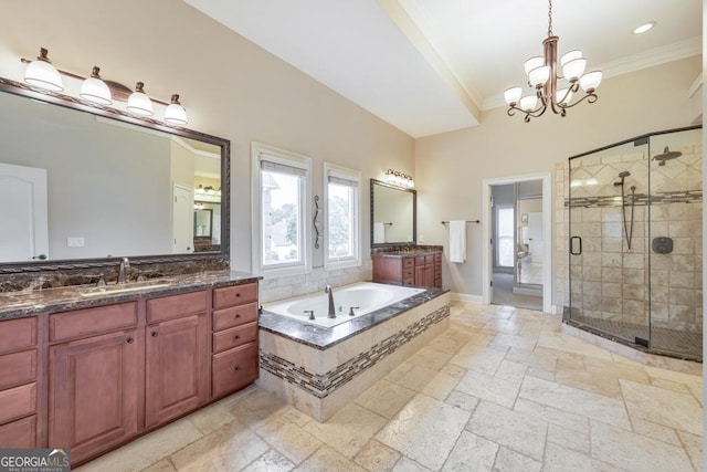 full bath featuring a shower stall, a sink, stone tile flooring, an inviting chandelier, and ornamental molding
