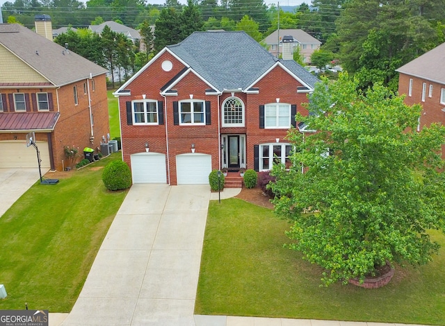view of front of house featuring a garage, driveway, brick siding, and a front yard