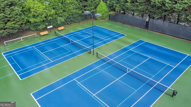 view of tennis court with fence and community basketball court