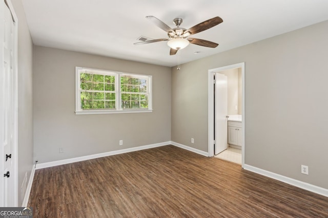 unfurnished bedroom with baseboards, wood finished floors, and visible vents