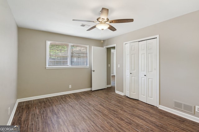 unfurnished bedroom featuring visible vents, baseboards, and wood finished floors