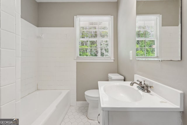 full bath with shower / bath combination, vanity, tile patterned flooring, and toilet