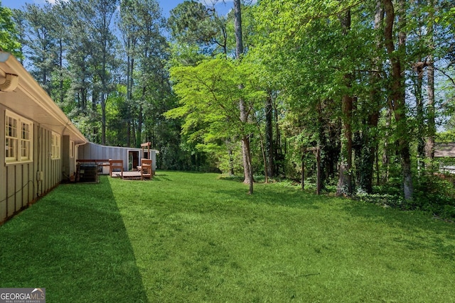 view of yard featuring central air condition unit