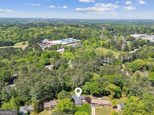 birds eye view of property featuring a view of trees