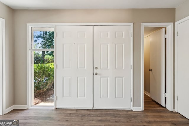 foyer with baseboards and dark wood finished floors