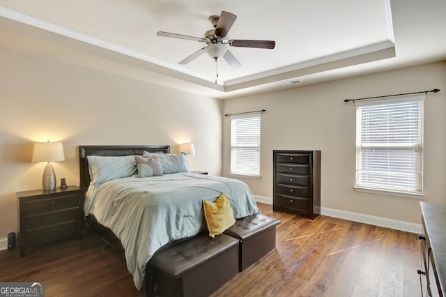890 Crescent Ln, Griffin, GA 30224 - bedroom featuring a raised ceiling, wood finished floors, and ceiling fan