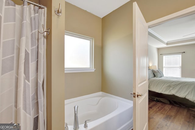 890 Crescent Ln, Griffin, GA 30224 - ensuite bathroom with a garden tub, wood finished floors, and a shower with shower curtain