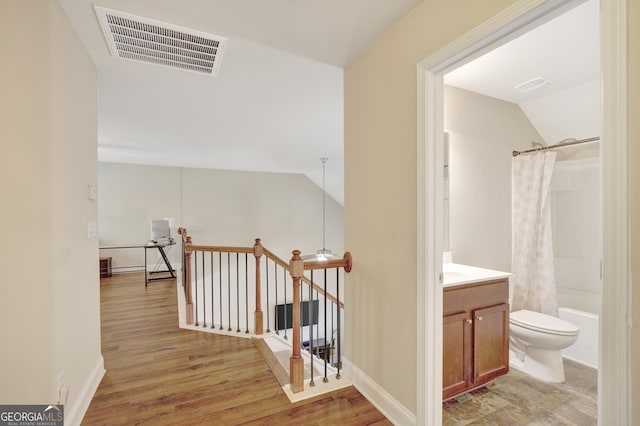 890 Crescent Ln, Griffin, GA 30224 - hallway featuring an upstairs landing, vaulted ceiling, and light wood finished floors