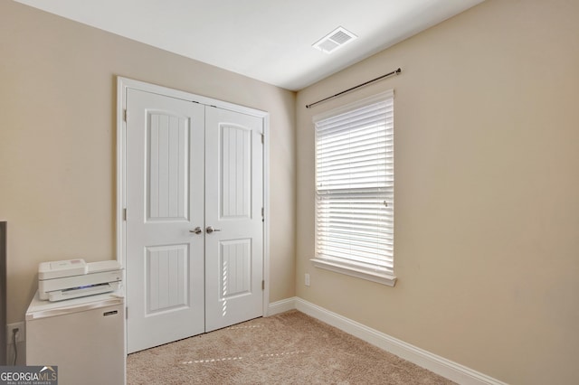 890 Crescent Ln, Griffin, GA 30224 - unfurnished bedroom with a closet and light carpet