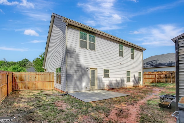 890 Crescent Ln, Griffin, GA 30224 - rear view of house with a patio area, a fenced backyard, and a fire pit