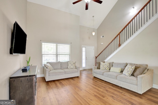 890 Crescent Ln, Griffin, GA 30224 - living area with high vaulted ceiling, ceiling fan, wood finished floors, and stairs