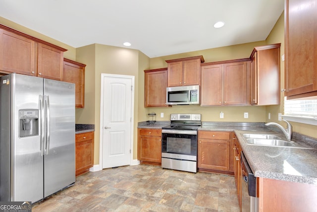 890 Crescent Ln, Griffin, GA 30224 - kitchen with stainless steel appliances, light stone finish flooring, brown cabinetry, and recessed lighting