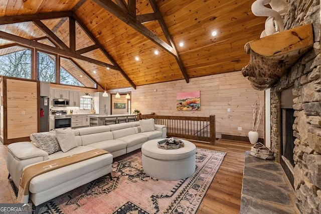 living room featuring wood ceiling, high vaulted ceiling, wood-type flooring, and beam ceiling