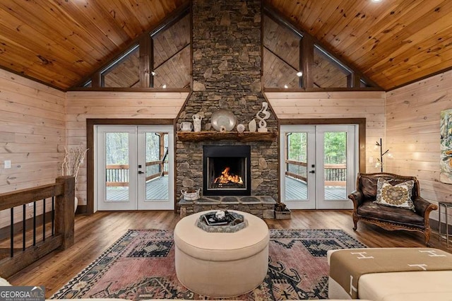 living room with wood ceiling, french doors, wooden walls, and a wealth of natural light