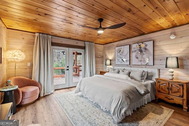 bedroom with wood walls, access to exterior, wooden ceiling, and wood finished floors