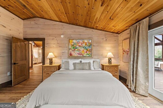 bedroom with wood walls, access to exterior, lofted ceiling, wooden ceiling, and wood finished floors