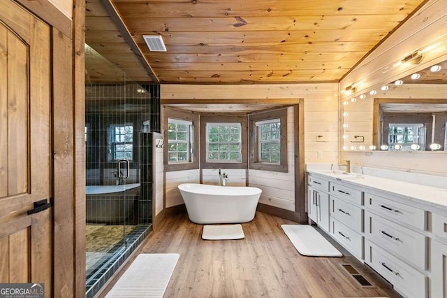 full bath featuring a shower stall, vanity, wood ceiling, and visible vents
