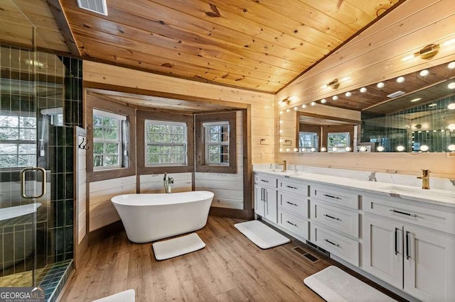 full bathroom featuring a sink, wood ceiling, a shower stall, double vanity, and wood finished floors
