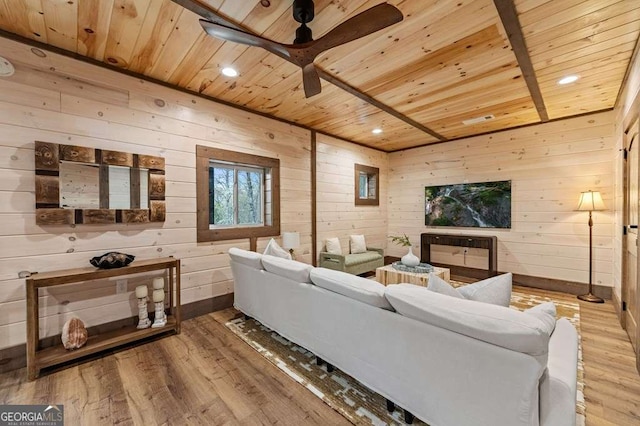living room with baseboards, wooden ceiling, a ceiling fan, wooden walls, and light wood finished floors