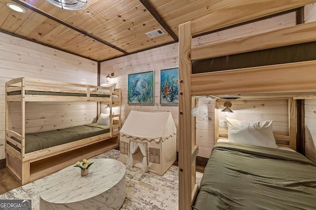 bedroom featuring wooden walls, visible vents, and wooden ceiling