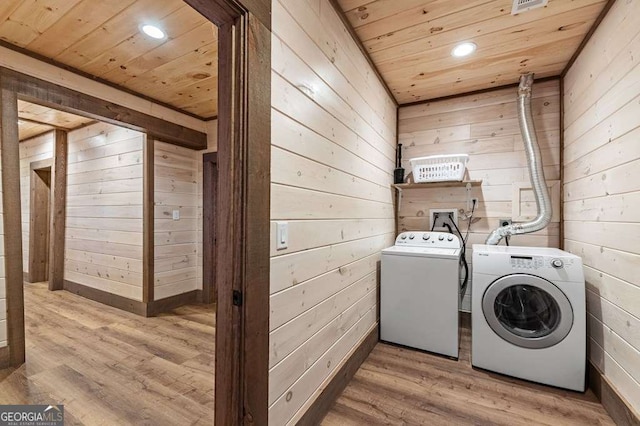 laundry room with laundry area, recessed lighting, wooden ceiling, wood walls, and washing machine and dryer