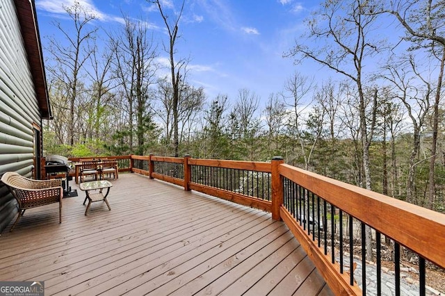 wooden deck with grilling area and outdoor dining space