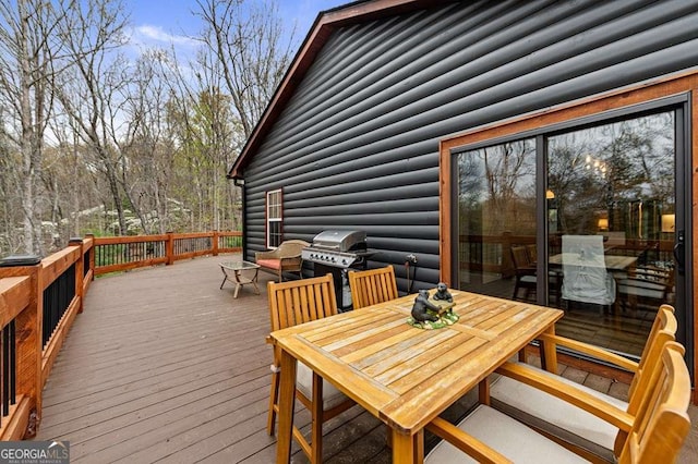 deck with area for grilling and outdoor dining space