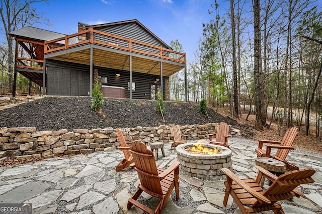 view of patio with a fire pit and a deck