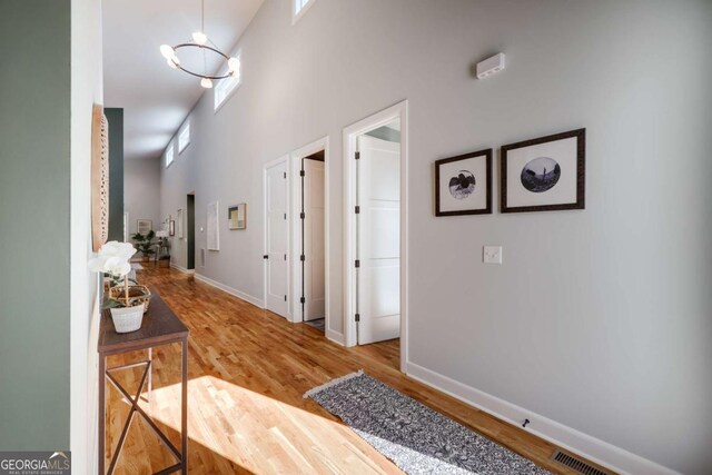 290 Hodgson Dr, Athens, GA 30606 - hallway with a towering ceiling, visible vents, baseboards, and wood finished floors