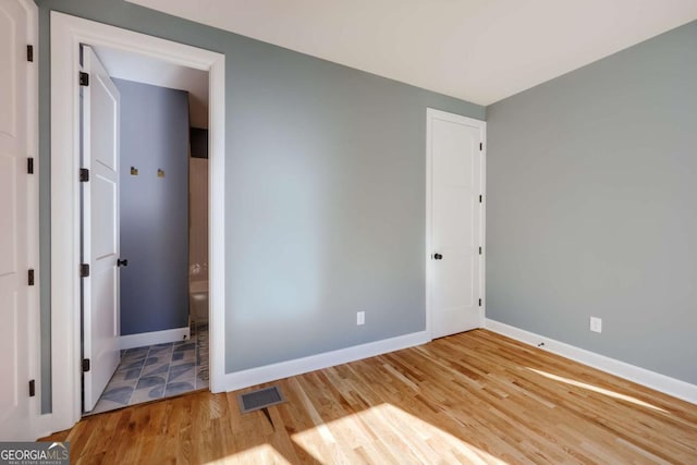 290 Hodgson Dr, Athens, GA 30606 - unfurnished bedroom featuring wood finished floors, baseboards, and visible vents