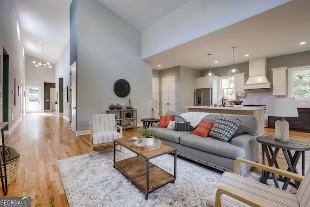290 Hodgson Dr, Athens, GA 30606 - living area featuring baseboards, a chandelier, light wood-style floors, recessed lighting, and high vaulted ceiling