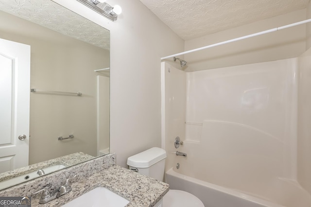 full bathroom featuring washtub / shower combination, toilet, and vanity