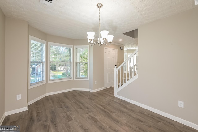 unfurnished dining area with baseboards, dark wood-style flooring, a chandelier, recessed lighting, and stairway