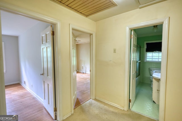 hall featuring baseboards